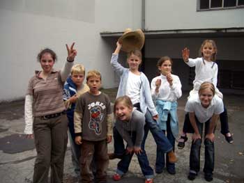 Das Foto zeigt acht Kinder vor dem Gebäude Studiobühne